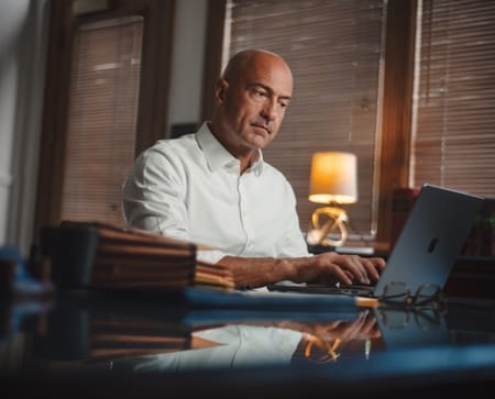 Man working at a desk on a laptop in a law office.